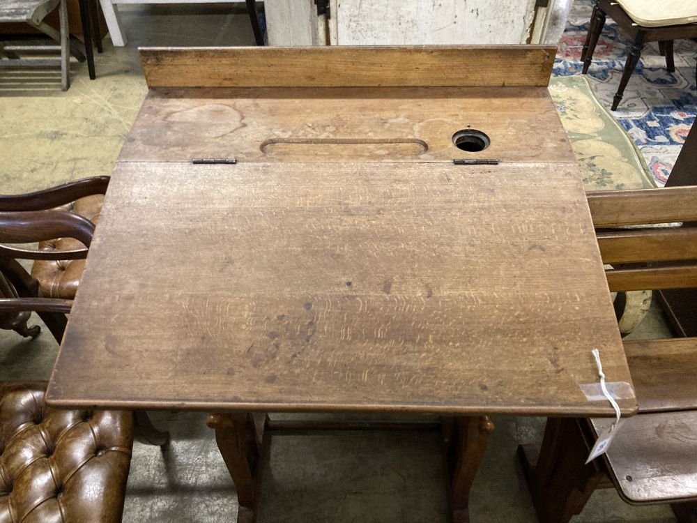 A 19th century Continental oak metamorphic rise and fall students desk together with a matching chair, desk width 66cm
